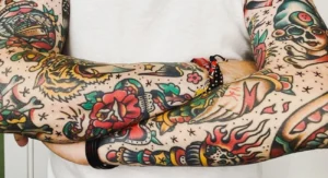 Colorful traditional tattoos covering both arms
